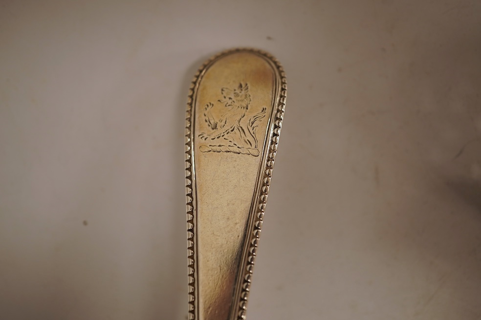 A George III silver fiddle pattern stilton scoop, John Lias, London, 1816, 20cm, together with two Georgian silver sauce ladles, a similar sifter ladle and a William IV shell pattern fish knife, 8.9oz.